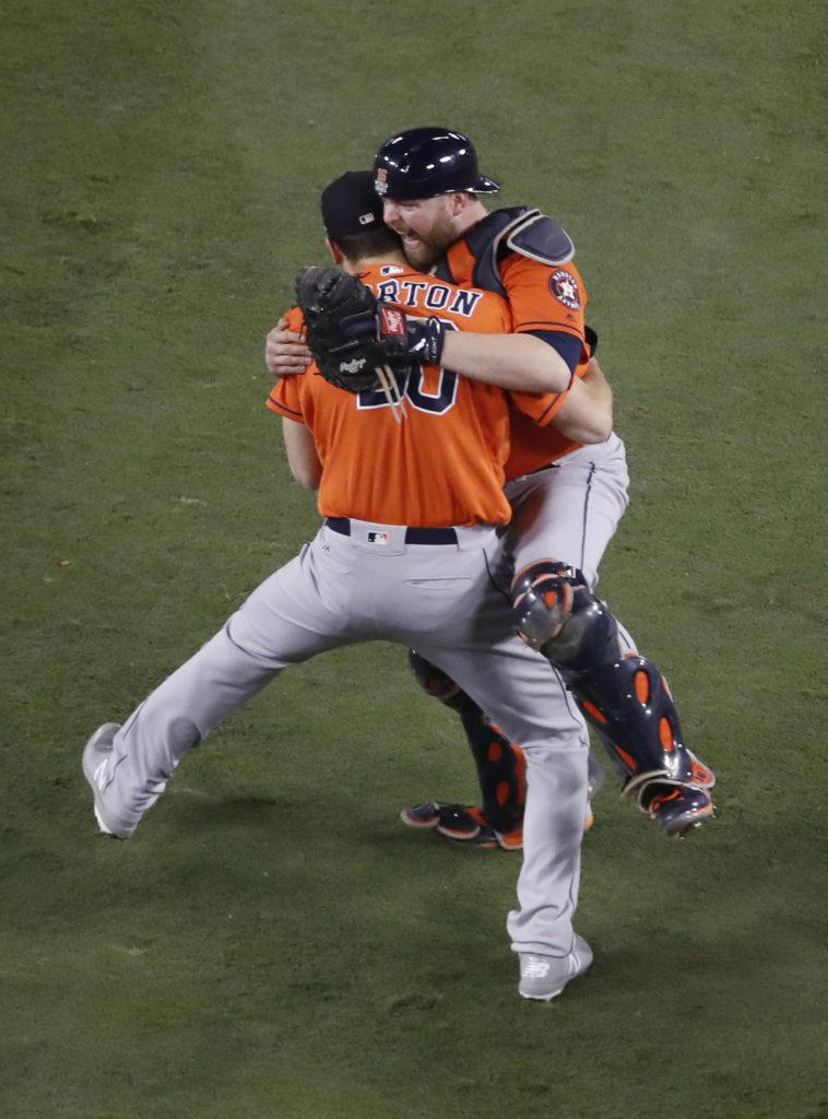 The Houston Astros catcher Brian McCann jumps on pitcher Charlie Morton after he held the Dodgers to one run over the last four innings to preserve the win and celebrate their 5-1 victory over the Dodgers in Game 7 to win their first World Series at Dodger Stadium Wednesday, Nov. 1, 2017 in Los Angeles. (Allen J. Schaben/Los Angeles Times/TNS)