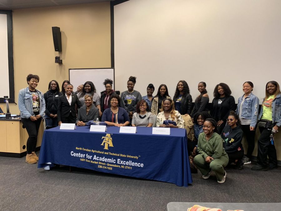 Alumnae and participants pose for a photo after the discussion.