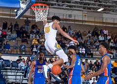 Tyrone Lyons completes a dunk in a home game.