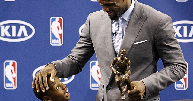 LeBron James, right, chats with his son LeBron James Jr. after having accepted the NBA MVP trophy, Saturday, May 12, 2012 in Miami. Calling the honor overwhelming but pointing to a bigger goal, James on Saturday became the eighth player in NBA history to win the MVP award three times. (AP Photo/Wilfredo Lee)