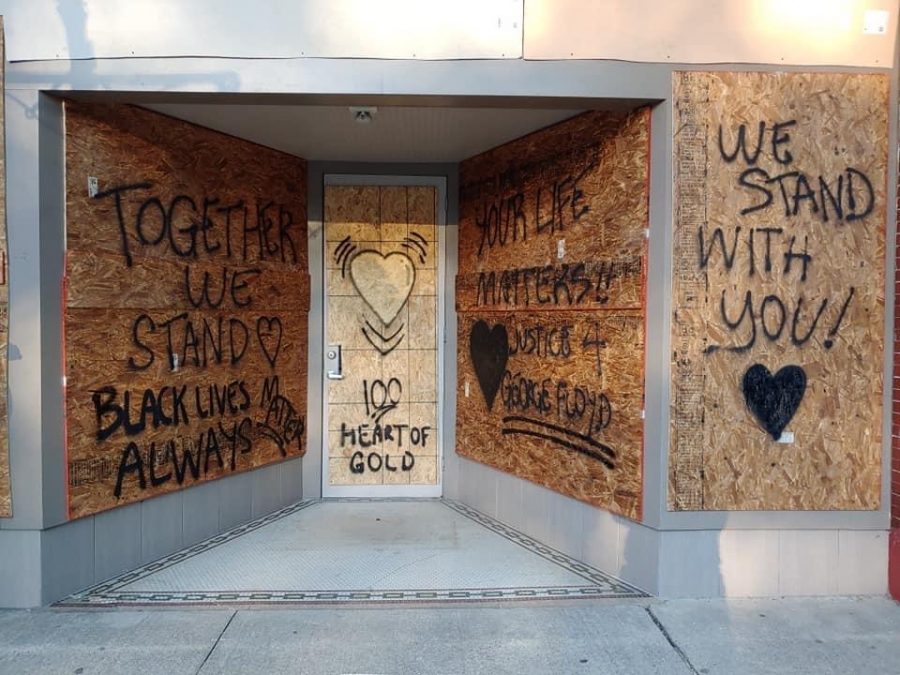 Message spray-painted on boarded up windows. 