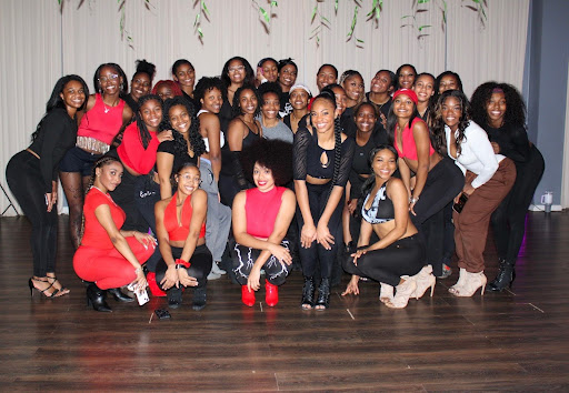 Bennett poses with participants at a dance class.