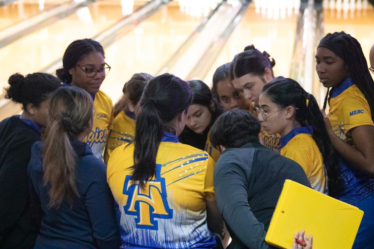 Aggie bowlers and coaches huddle up following a win during the meet.      