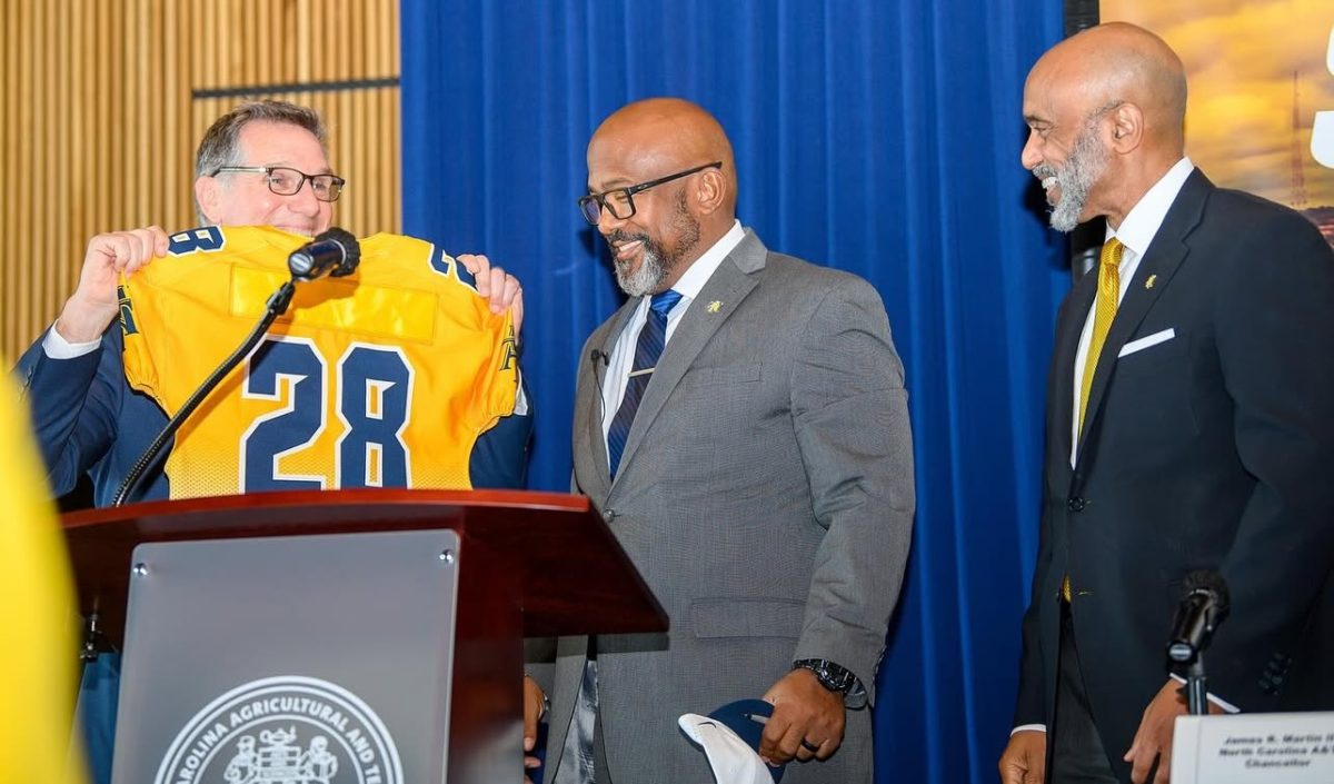 Athletic Director Earl Hilton III (left) introduces Coach Gibbs alongside Chancellor Martin (right)