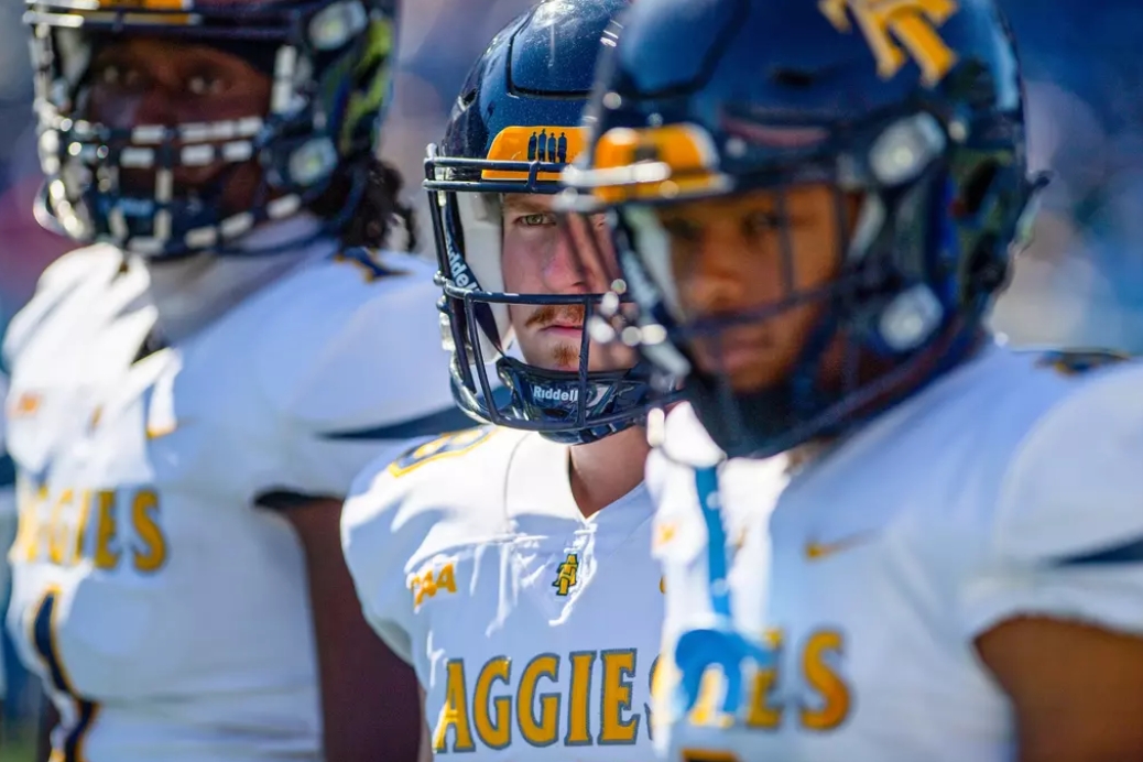 Close shot of A&T players watching from sideline