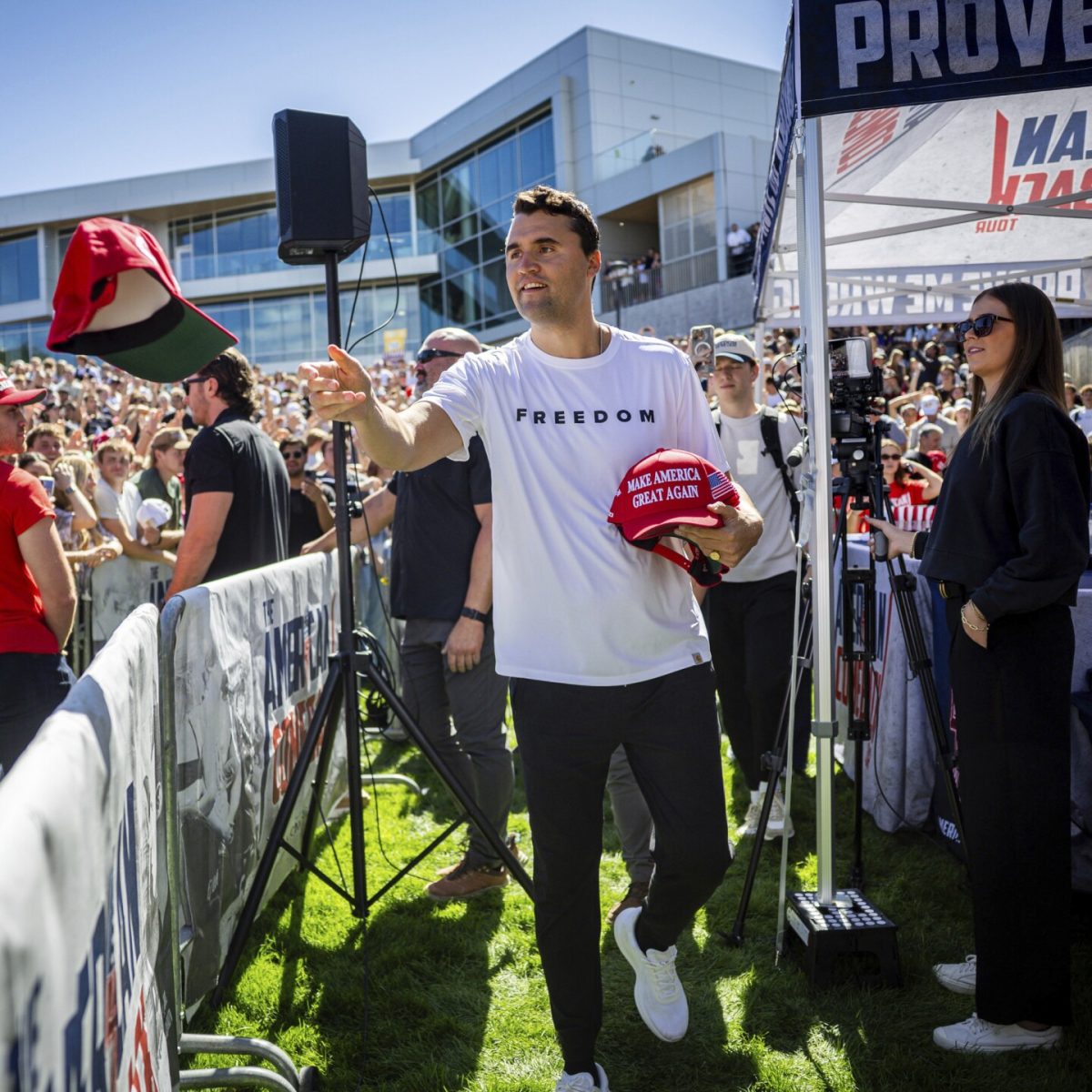 Charlie Kirk handing out hats before delivering a speech at Utah Valley University where he was shot. Picture by Tess Crowley, The Deseret News via AP 
