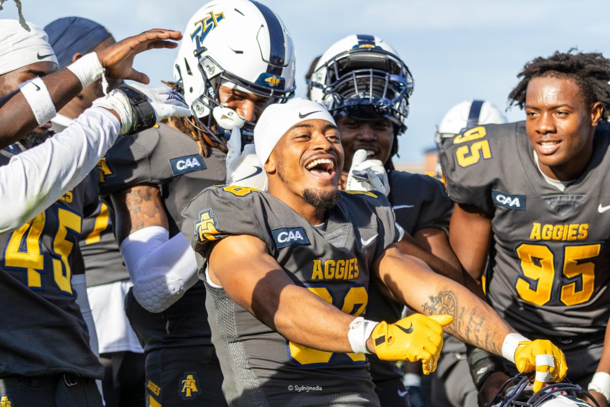 Elijah Kennedy (#88) celebrates win against Campbell with team.