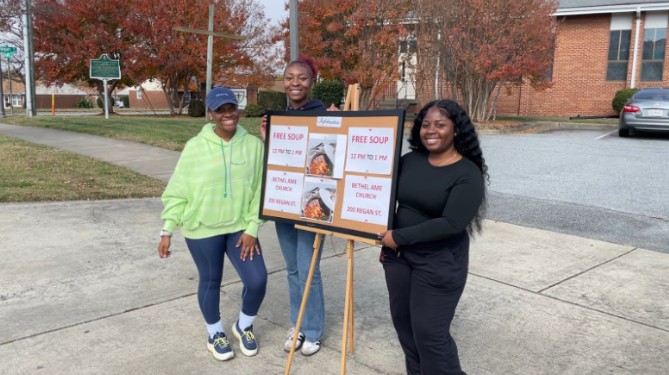 People helping promote the free food program at Bethel AME Church