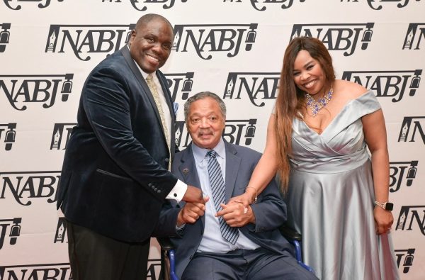 Former NABJ president, Ken Lemon and his wife, Dr. Kortni Alston Lemon, pose with the late Reverend Jesse Jackson Sr. at the 2024 NABJ conference in Chicago.